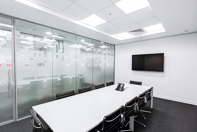 Mature professional financial advisor meeting with senior clients in a bright modern office