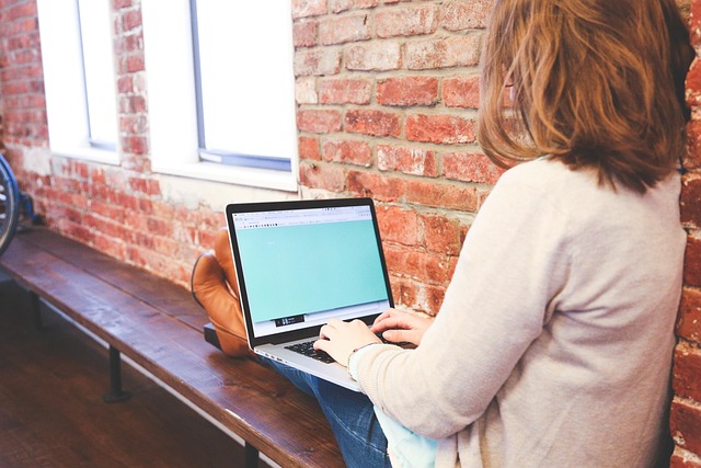 Senior person carefully reviewing financial plan details on a computer screen with reading glasses